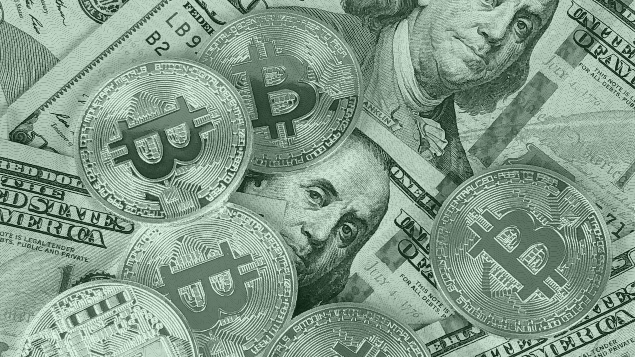 Photo of Bitcoin coins on top of 100 dollar bills