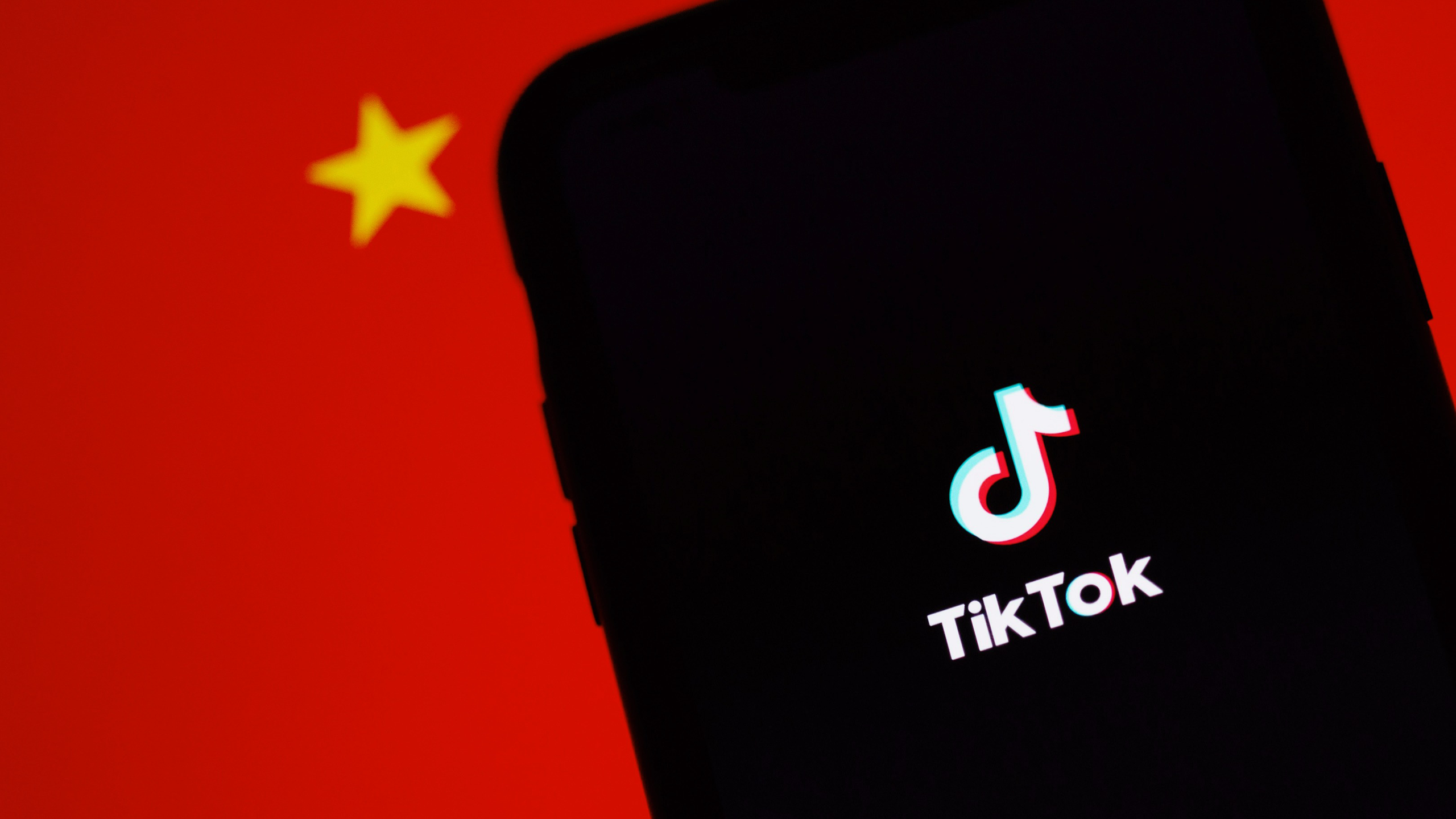 Photo of Tiktok app on an iPhone in front of the Chinese flag